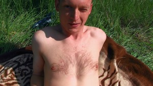 Cutesy young guy seduced next to a field of flowers